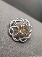 Front view showing brooch design and stone