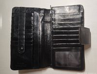Wallet opened showing card slots, ID window, compartments