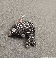 Front view showing black stone pavé and clear stone eye