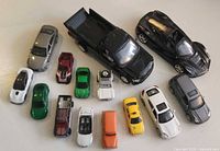Group shot of mixed vehicles including two larger scale pieces and several smaller cars