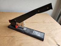 Full view of black Bostitch heavy duty stapler with handle raised