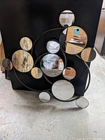 Front view showing entire clustered circular mirror artwork