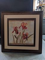 Front view showing floral print, matting and wooden frame