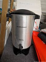 Front view of Hamilton Beach stainless steel coffee urn with lid, handles and spigot