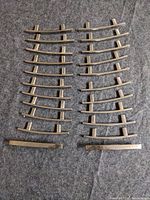 Full set of 22 curved metal pulls displayed in two rows