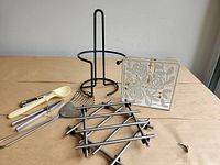 Group shot showing paper-towel holder, napkin holder, trivet and utensils