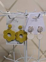 Both earring pairs on display cards