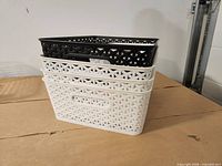 Stacked view showing medium black basket atop three medium white baskets