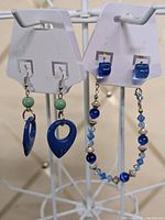 Front view showing both earring pairs on cards and bracelet