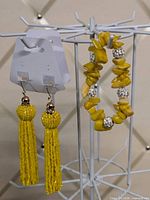 Earrings on display card and stretch bracelet on rack