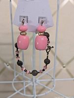 Front view of earrings and bracelet hanging on display card