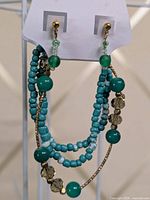 Earrings and bracelet displayed on card