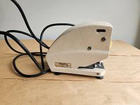 Left side view showing overall stapler and label plate