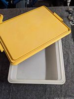 white/grey base with yellow lid lifted