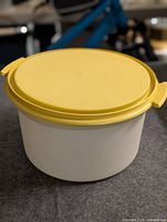 Angled view of closed container showing lid color and tab handles