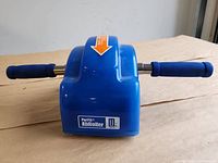 Front view of blue PurFit AbRoller showing brand label and handles