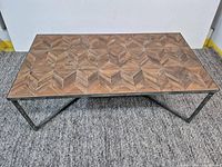 Full view of rectangular coffee table showing wood parquet top and metal base