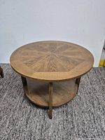 Full view of assembled round accent table showing top, supports and lower shelf