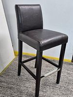 Full view of assembled black leather bar stool