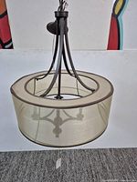 Full view of assembled chandelier showing bronze frame and shade