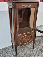 Full view of vitrine cabinet showing glass panels, marquetry, ormolu mounts, cabriole legs