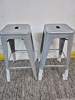 Both silver metal bar stools front view