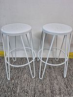 Both assembled white metal bar stools side by side