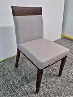 Front three-quarter view of chair showing overall design, wood frame and fabric seat