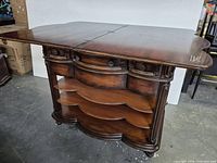 Island bar with drop-leaf top extended