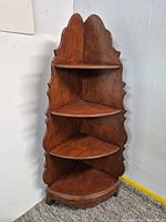 Full view of wooden four-tier corner étagère