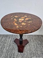 Full view of round marquetry top table on pedestal base