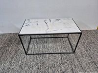 Full view of marble top table on carpet
