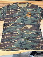 Front view of camo T-shirt showing chest logo