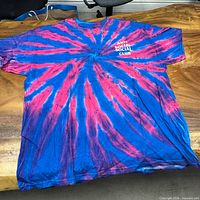 Front of blue and pink tie-dye T-shirt showing small chest logo