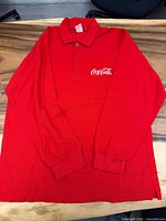 Front view of red Coca-Cola long sleeve polo shirt