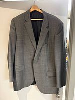 Full front view of grey plaid Hugo Boss suit jacket on hanger