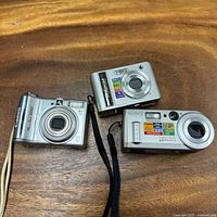 Front view of all three cameras showing lenses, branding, megapixel labels and straps