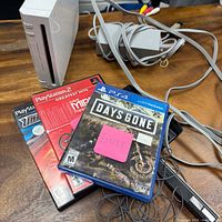 Console, cables and empty game cases overview