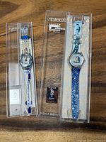 Both watches in original cases, front view