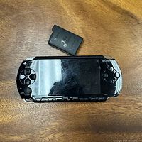 Front view of Sony PSP-1001 console with battery pack