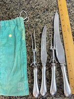 Full view of two knives, two forks with ruler and pouch