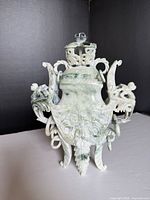 Front view of carved stone incense burner displaying elephant handles, rings, legs, lid in place