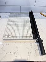 Top view of full paper trimmer showing grid and cutting arm