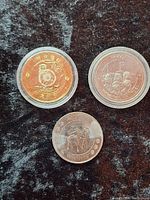 Group shot showing all three coins with capsules