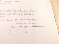 Close-up of J. Edgar Hoover's signature on typed letter showing signature and part of letter text.