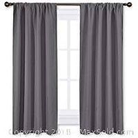 Two gray drape panels hanging on curtain rods showing regular top design and window coverage.
