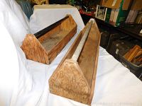 Photo showing two wooden tool chests placed side by side on white cloth background in a warehouse setting.