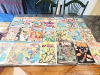 Photo showing a collection of 18 vintage comic books laid out on a table, featuring multiple Wolverine, X-Men, and New Warriors issues in protective sleeves.