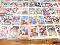 Close-up photo showing a detailed view of multiple baseball cards on one sheet, showcasing players in various baseball poses and team uniforms from the 1980s era.
