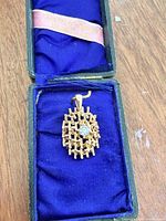 Pendant in presentation box showing overall design and size